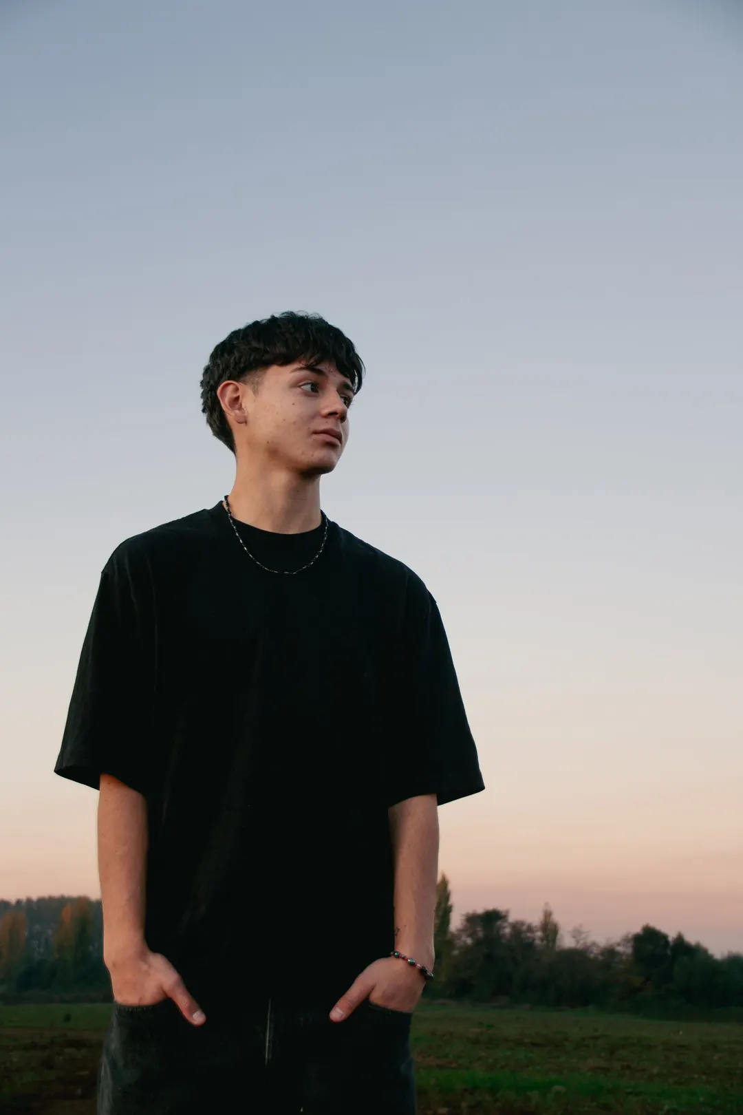 Joven mirando al horizonte al atardecer